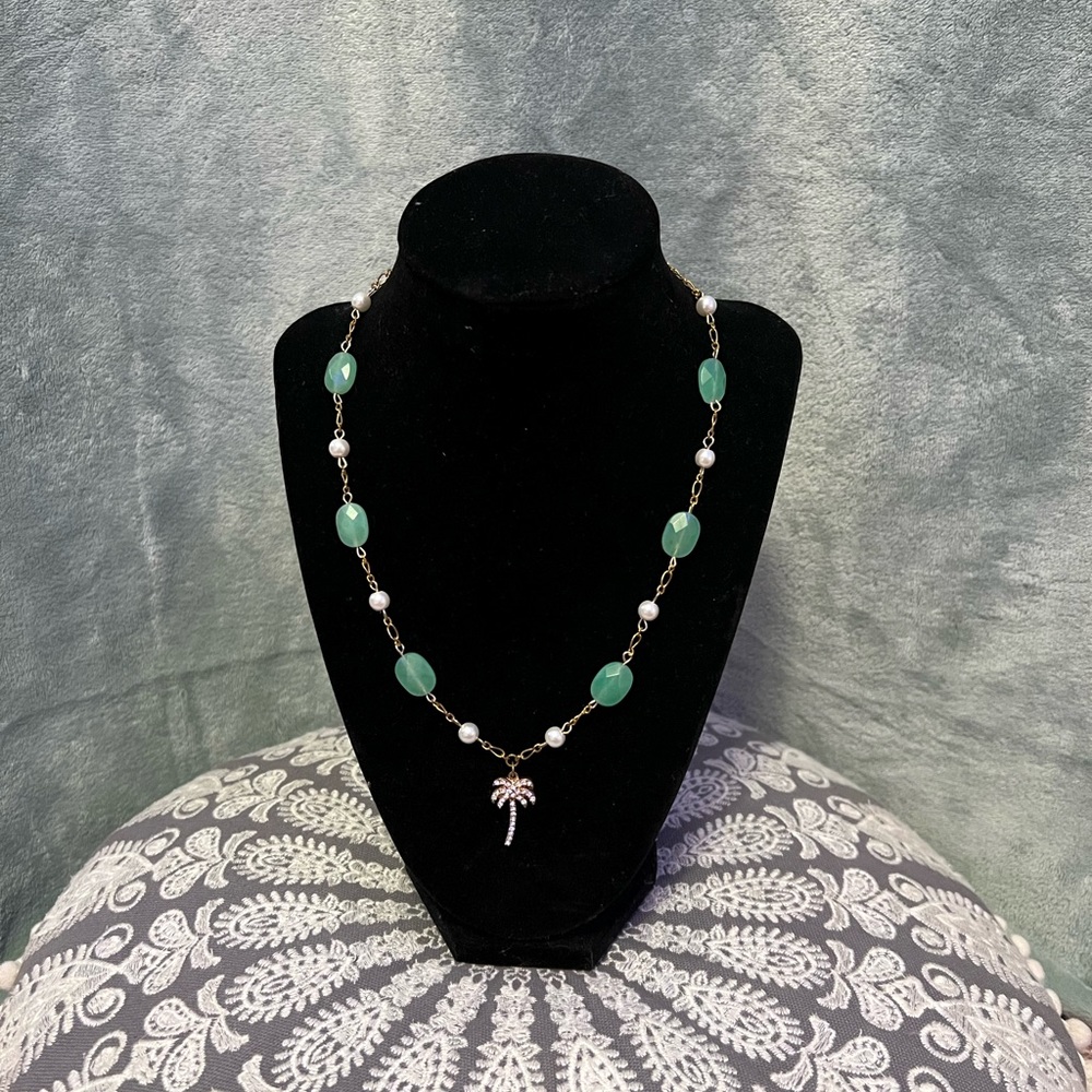 green and gold necklace with pearls and palm tree